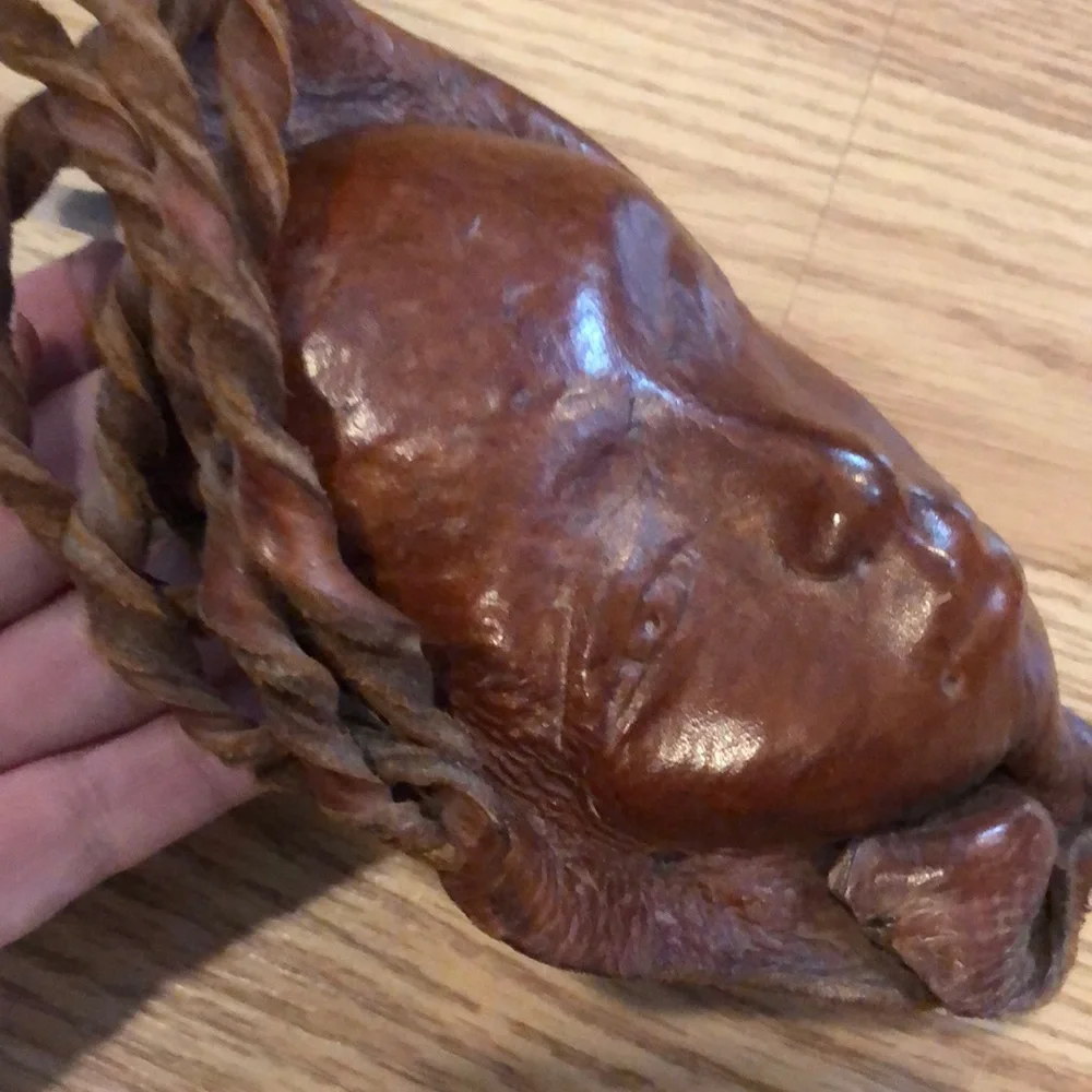 VINTAGE HAND MOLDED LEATHER WOMAN AND CHILD FACES